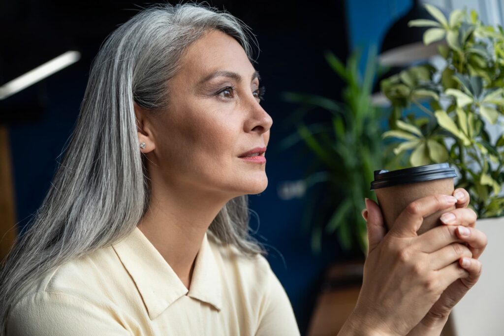 An older woman contemplates the best facial contouring treatment for her