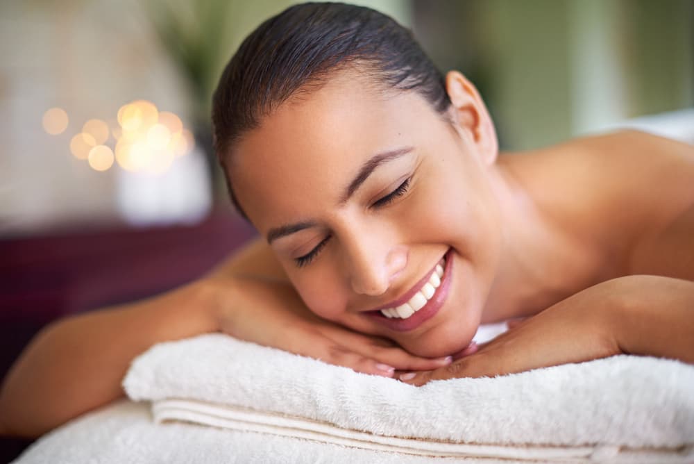 A woman relaxing on a med spa treament bed before RF Microneedling in Homewood